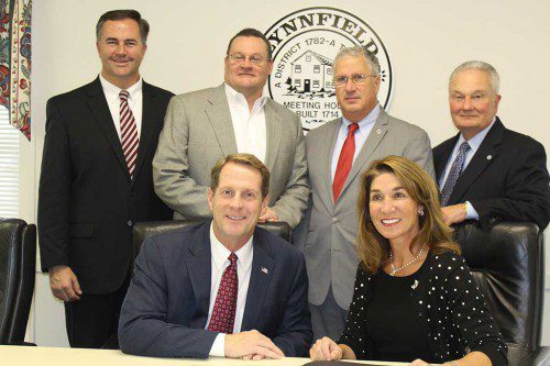 THE TOWN signed a Community Compact agreement with Lieutenant Gov. Karyn Polito on Dec. 1. Sitting are Selectmen Chairman Phil Crawford and Polito. Standing, from left, Selectman Chris Barrett, State Rep. Brad Jones (R-North Reading), State Sen. Tom McGee (D-Lynn) and Selectman Dick Dalton. (Dan Tomasello Photo) 
