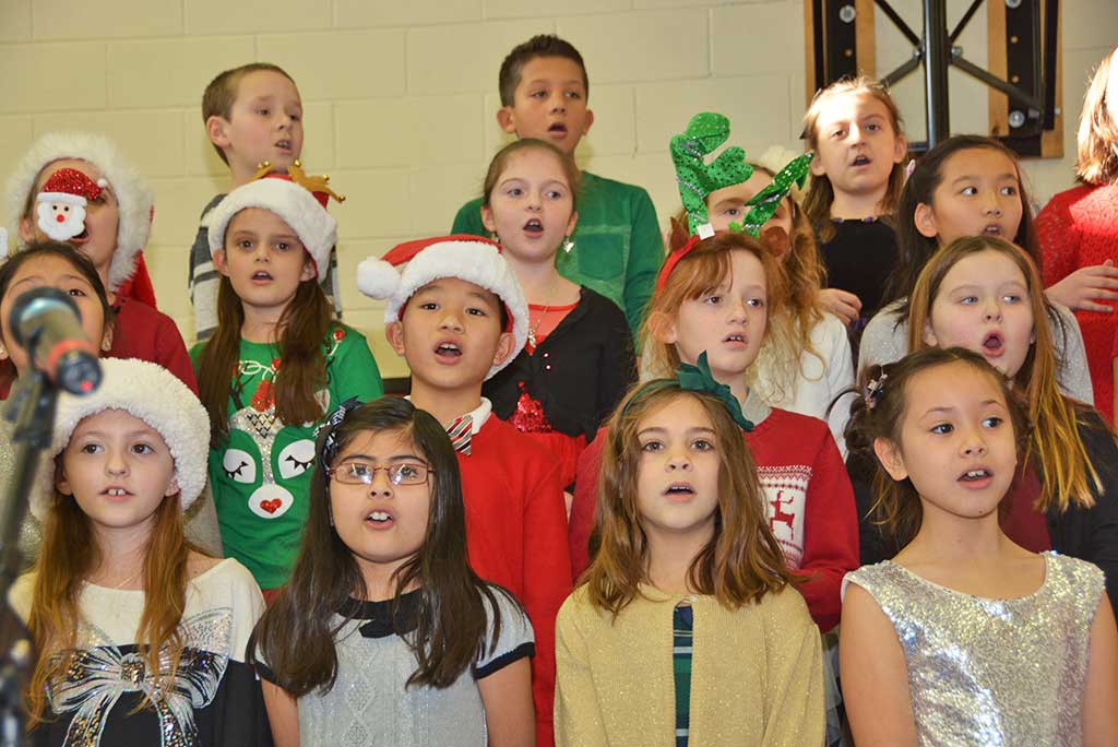 LITTLE SCHOOL THIRD GRADERS rock out while singing The Jingle Jive at the school’s annual Holiday Concert on Tuesday. (Bob Turosz Photo)