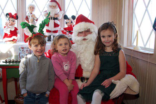 GETTING A CHANCE to tell Santa what they want for Christmas are 5-year-old Isaac Davis, Sara Davis, 3, and Nora Quinn, 5. (Donna Larsson Photo)