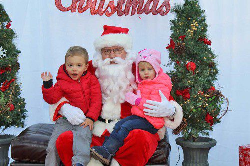 SIBLINGS Declan (left) and Genevieve Brooks were full of excitement while telling Santa Claus what they want for Christmas during the Tree Lighting ceremony Dec. 3. (Dan Tomasello Photo)