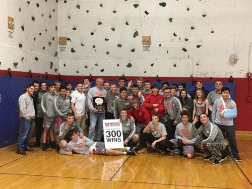 THE WMHS wrestling team celebrates Head Coach Ross Ickes’ 300th career win on Saturday at Watertown High School. Ickes earned his 299th and 300th wins as the Warriors defeated both Taunton and Carver.