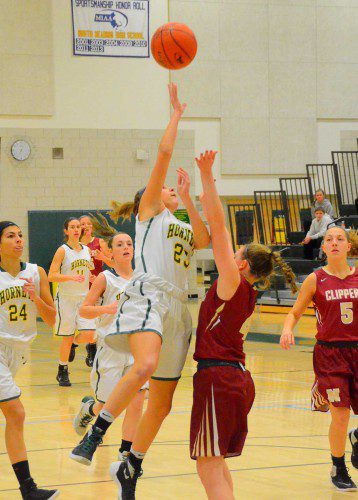 SOPHOMORE Mia DeNofrio (23) puts up a shot in the lane early in the game (John Friberg photo).