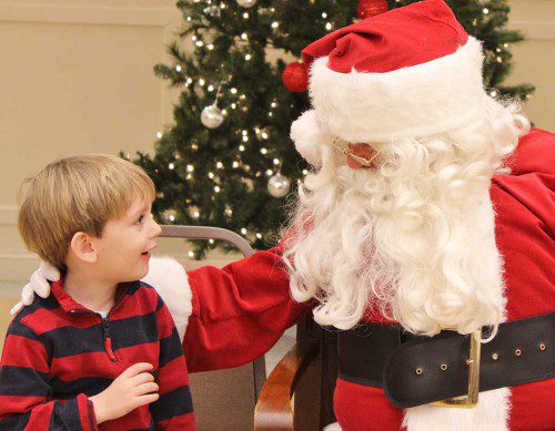 LITTLE Vincent Reed, 3, was in awe of the man in the big red suit when they met during Breakfast with Santa held at St. Maria Goretti Church. See story, more photos inside. (Marie Lagman Photo)