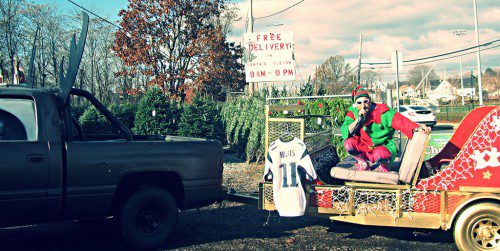 THE CHRISTMAS TREE ELF (aka Mike Shiner) is ready to deliver your Christmas Tree from Designer Lawn Sprinkler Service at 64 North Ave. The Elf will deliver your tree to your door in his custom sleigh pulled by “Rudolph Truck.” (Mark Sardella Photo) 