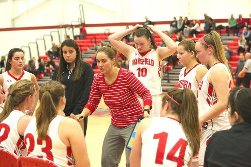 THE WMHS girls' basketball team gets instruction from head coach Meg O'Connell (center) during the Reading game. The Warriors increased their record to a perfect 3-0 on the season with a decisive 46-28 win over Arlington last night at the Tozlowski Red Gym. (Donna Larsson Photo)