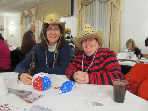 GETTING INTO THE SPIRIT of an indoor barbecue were Barbara Worley of Wakefield, at left, and Kim Vetters of Reading. (Gail Lowe Photo)