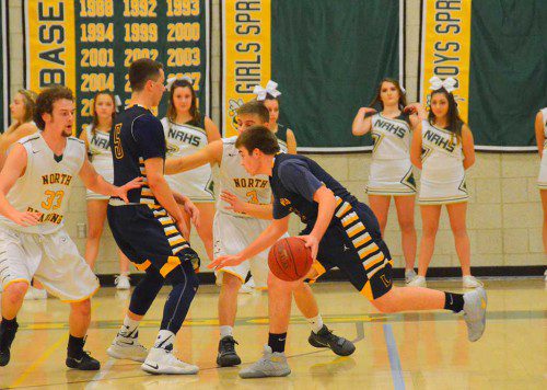 POINT GUARD Billy Arseneault (11) attempts to drive to the hoop during the boys’ basketball team’s 68-57 win over North Reading Jan. 3. (John Friberg Photo)