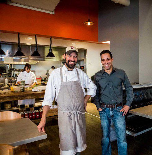 BROTHERS Louis (left) and Michael DiBiccari are cooking and serving delicious food at their restaurant Tavern Road in Boston’s Fort Point neighborhood. (Courtesy Photo)