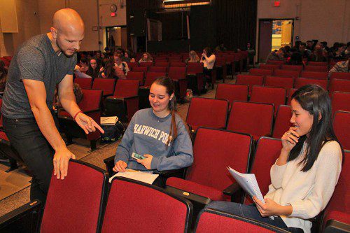 DISNEY ANIMATOR Stephen Wright gives drawing tips to sophomores Shelby Considine (center) and Zoe Chen during a workshop held at Lynnfield High School recently. (Dan Tomasello Photo) 