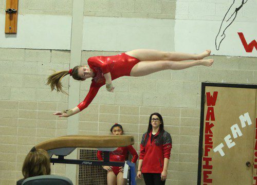 ELISE RICH, a freshman, competes on vault during Wakefield’s meet against Melrose on Tuesday at WMHS. Rich came in fourth place with a score of 8.2. Rich also won the uneven bars (8.35) and finished third on floor (8.0). (Donna Larsson Photo)