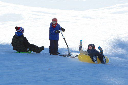 SLEDDING IS SOMETHING to be enjoyed with friends, like it was for these three behind the high school Sunday. (Donna Larsson Photo)