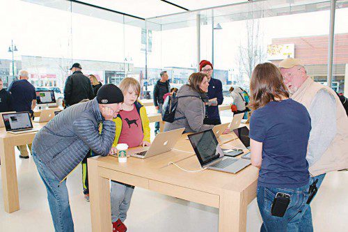 WILL RENFORE, 10, and his dad Mike (at left) were among the first customers to attend the opening of Apple’s newest store on Saturday at MarketStreet Lynnfield. (Maureen Doherty Photo)