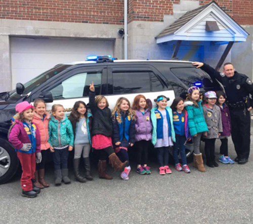 North Reading Daisy Troop 62550 recently paid a visit to the North Reading Police Station. In this photo, Officer LeBlanc is showing the kids one of the department’s vehicles. Fun was reportedly had by all. (Courtesy Photo)