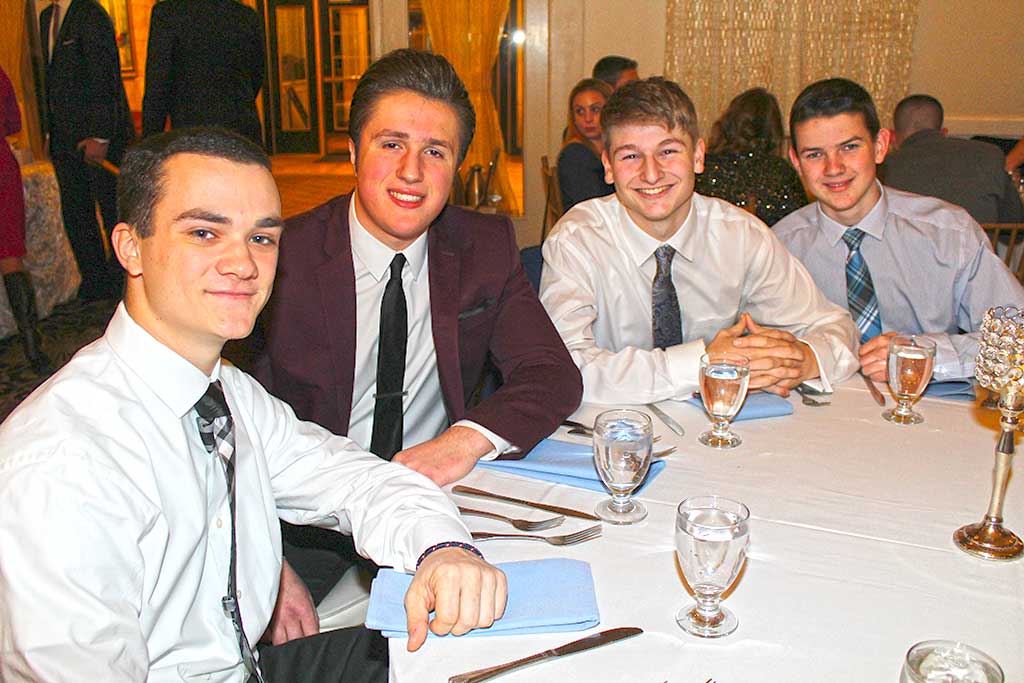 CLOSE FRIENDS, from left, Mike Palmer, Sal Noto, Cameron Comeau and Harry Drislane had a blast at Lynnfield High School’s annual Snowball dance at the Danversport Yacht Club Jan. 28. (Dan Tomasello Photo)