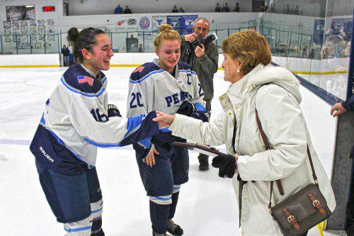 CO-OP GIRLS’ HOCKEY captains Caroline Buckley (left) and Elise Murphy accept the Carlin Cup championship plaque Monday night after shutting out the Bishop Fenwick Crusaders 4-0. (Mark Grant Photo)