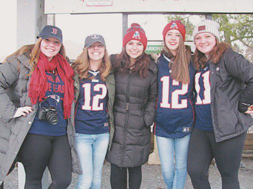 THESE YOUNG PATRIOTS fans were primed to celebrate the Patriots' Super Bowl victory at 8 a.m. this morning as they waited along with dozens of others at the commuter rail station on North Avenue to head into today's rolling rally in Boston. From left, sisters Samantha and Abby MacDonald, Roxana Margolis, Julia Desrocher and Mary Gerace. (Mark Sardella Photo)