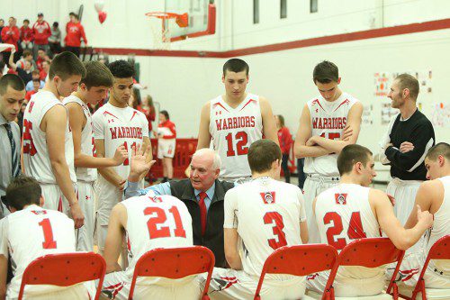 THE WARRIORS discuss a few matters during a time out of a recent game. The WMHS boys' basketball team clinched a state tournament berth with a 64-52 triumph over Tewksbury last night in the Sixth Annual Brad Sheridan Tournament which was held at Marblehead High School. (Donna Larsson File Photo)