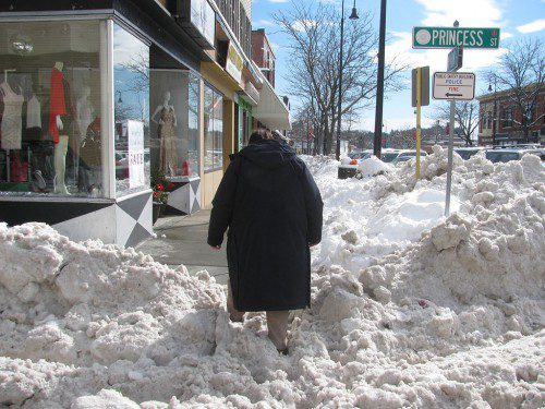 THE DPW cleaned up most of the snow piles in the square last night, making it an easier trek than this man had in the immediate aftermath of the last big storm. (Mark Sardella Photo)