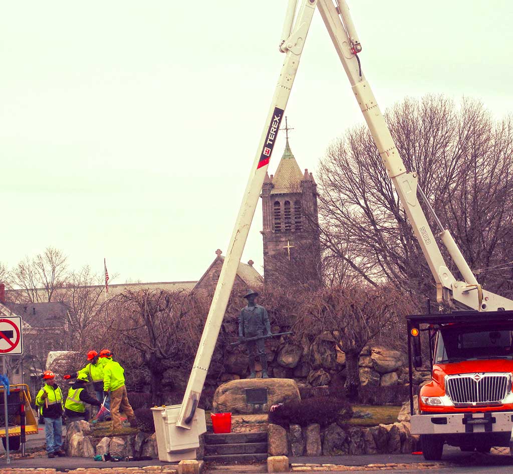 THE TOWN CHRISTMAS TREE met the wood chipper yesterday. DPW crews clean up after taking the tree down. (Mark Sardella Photo)