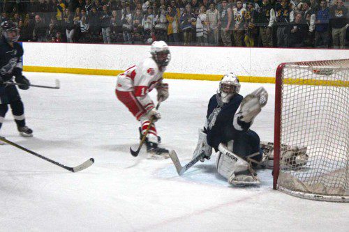 PIONEER NETMINDER David Langone comes up big with the glove in Friday’s game against Saugus at Woburn’s O’Brien Rink. (Keith M. Curtis Photo)