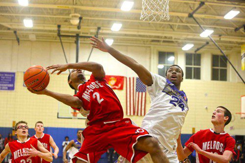 DEVONDRE WILLIAMS battles a New Mission defender during the opening round of the Div. 2 North playoffs. Melrose fell to the Titans, 56-46. (Donna Larsson photo) 