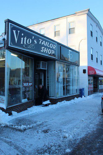 YESTERDAY MORNING, Vito Vacca shoveled out the front of his Albion Street tailoring business after a late winter nor'easter. (Colleen Riley Photo)