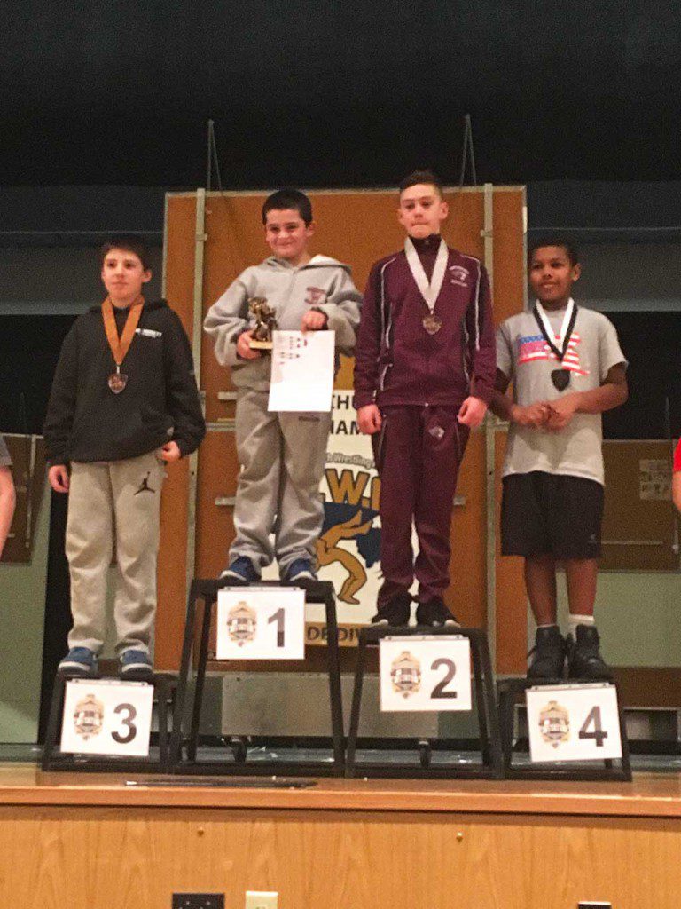 ZACH ARRIA, a fifth grader (second from left), was crowned the champion at 111 lbs. in the Youth Wrestling State Tournament which was held at Minnechaug Regional High School.