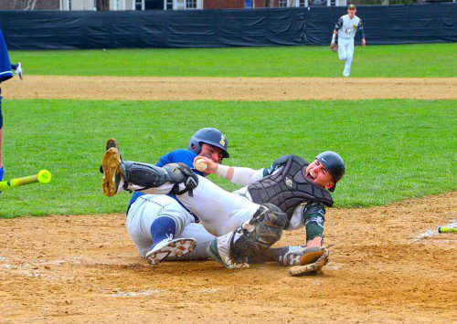 Senior catcher John Merullo somehow held onto the ball for an out despite being injured in this collision at the plate. (John Friberg photo)