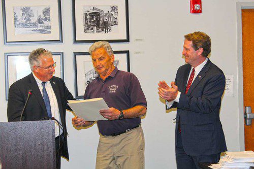 IN RECOGNITION of his upcoming induction into the National Wrestling Hall of Fame for a lifetime of service to the sport, Pioneer Coach Craig Stone (center) was presented with a citation from the state Legislature by state Sen. Tom McGee (left) as well as a letter of congratulations offered by both McGee and state Rep. Brad Jones at last week’s selectmen’s meeting. At right, is Selectman Phil Crawford. (Maureen Doherty Photo)