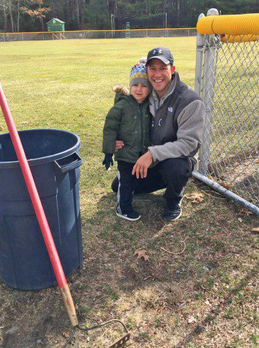 Jason Traino and his son Nicholas take a break during North Reading Little League’s Field Clean-up Day last Saturday at Benevento Fields. Their efforts – and those of several other coaches, players, and Board members – helped prepare the fields for this Saturday’s Opening Day. Nicholas will be participating in NRLL’s Tee-Ball Division for ball players ages 4-5. (Courtesy Photo)