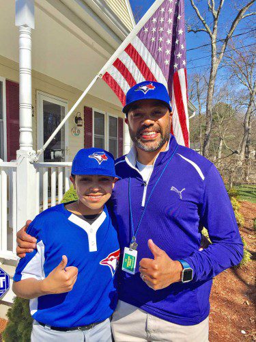 CELEBRATING AMERICA’S PASTIME. Jack Fischer (left) and his father, Mark, give the “thumbs up” prior to heading out to the North Reading Blue Jays’ opener against Lynnfield last Saturday in the Middlesex Big Diamond League. The Blue Jays scored a 15-7 victory. (Courtesy Photo)