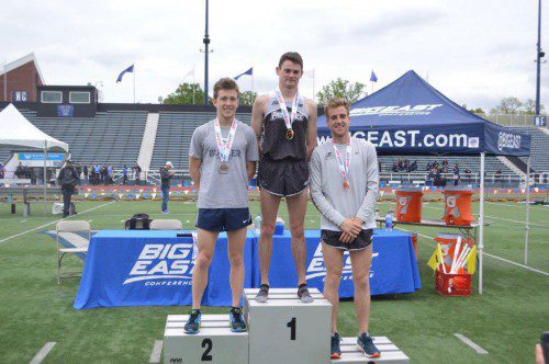 STEPHEN ROBERTSON (center) stands on the podium after becoming the Big East champion in the 10K. 