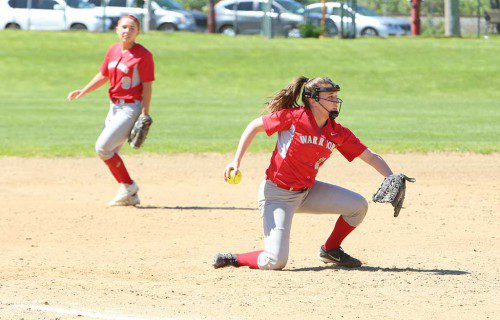 THIRD BASEMAN Vanessa Kaddaras (front) goes down to one knee while fielding the ball as shortstop Alexis Truesdale backs up the play. The Warriors softball team dropped an 8-4 game to Marblehead as its season came to an end. (Donna Larsson File Photo)