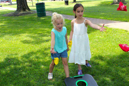 CC RAGALEVSKY (left) and Addie Wolf had a blast playing cornhole at the Lynnfield Public Library’s Summer Reading Kick Off Party on the Town Common June 23.  (Dan Tomasello Photo)