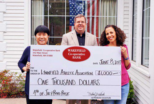 WAKEFIELD CO-OPERATIVE BANK is a returning sponsor of the Lynnfield Athletic Association (LAA) Fourth of July 5K Road Race. From left, Lynnfield Branch Manager Sam Lai, Wakefield Co-operative Bank President Michael Wolnik and LAA member Andrea Braconnier. (Courtesy Photo)