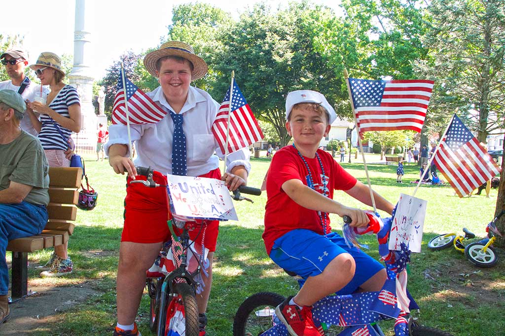 NINE YEAR OLD Calvin Bryant and Austin Bryant, 7, decked out their vehicles to reflect the “USA — United We Stand” theme of yesterday’s Fourth of July judged events on the Veterans Memorial Common. (Donna Larsson Photo)