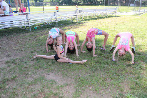 BENDING over backwards to enjoy a summer filled with fun activities at Recreation Station are (from left): Gabby D'Ambrosio, 8, Meagan Sloan, 8, Faye Allen, 9, and Allison Maddockl, 8, with Madison Sloan, 8, (foreground) adding a perfect split for good measure. (Maureen Doherty Photo)