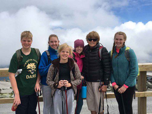 GREETINGS from Mount Washington! North Reading resident Karen von Sneidern greeted her grandchildren at the 6,288-foot summit of Mount Washington after the kids hiked the mountain with her son, Kurt. She chose to reach the summit via its iconic Cog Railway. From left: William Carlson, Emma von Sneidern, Gretchen Carlson, Sarah von Sneidern, Karen von Sneidern and Kathryn Carlson. (Kurt von Sneidern Photo)