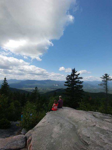 WAKEFIELD RESIDENTS Frances Corcell and Tynan Connors enjoy the view from the summit of the Black Cap Trail in North Conway, NH, during vacation.