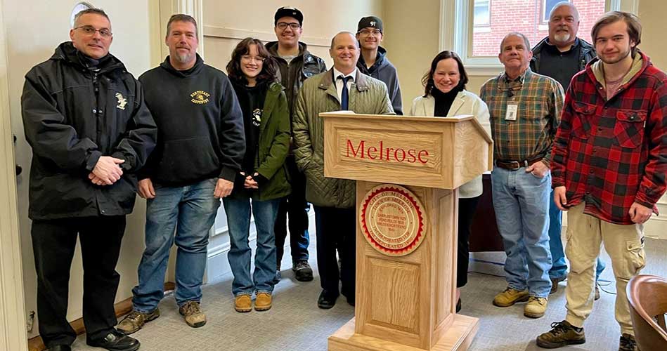 Melrose Mayor Jen Grigoraitis receives a new podium